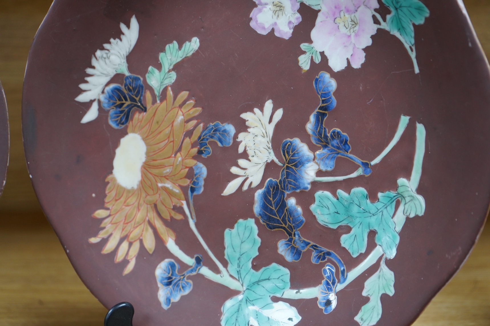 A pair of Japanese relief plates with brown glaze, 28cm high